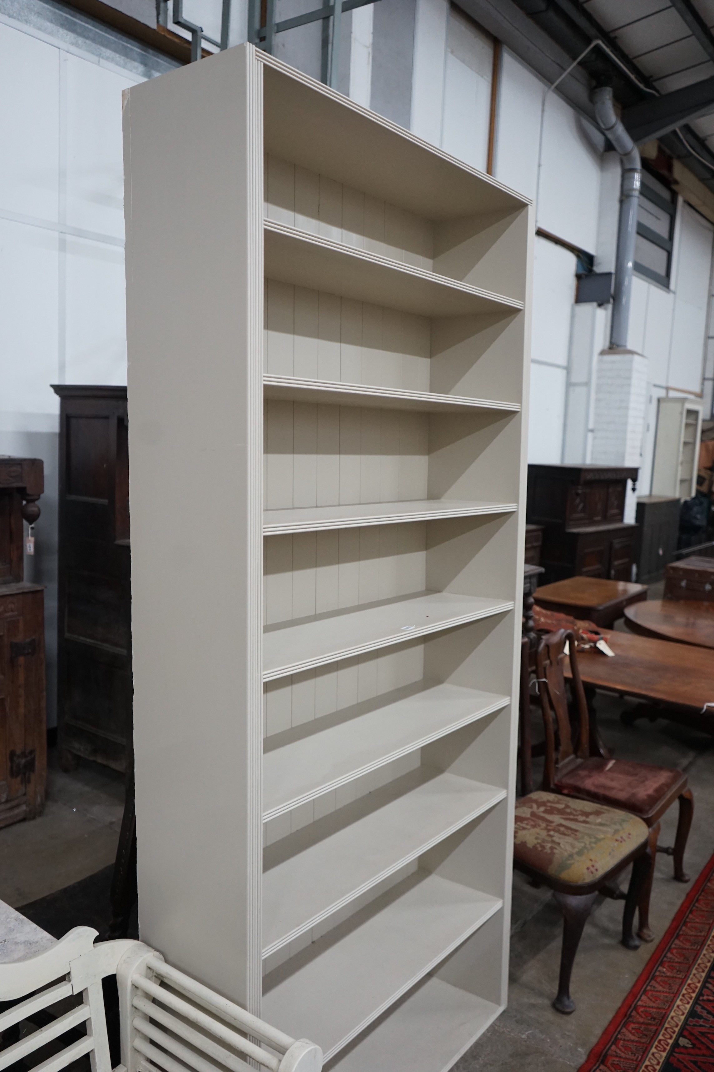 A painted open bookcase, width 109cm, depth 33cm, height 232cm